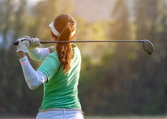 Junior golf girl playing in the sun with uv protection