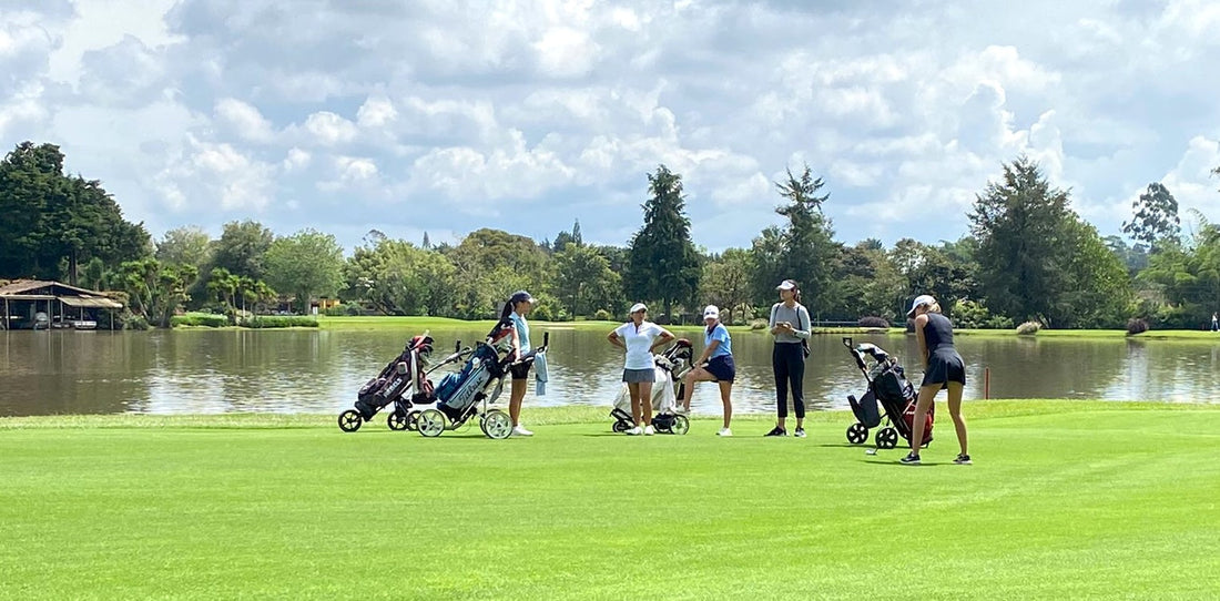 Junior girl golfers on a tournament on a sunny golf course, highlighting the need for sun protection during long hours on the green